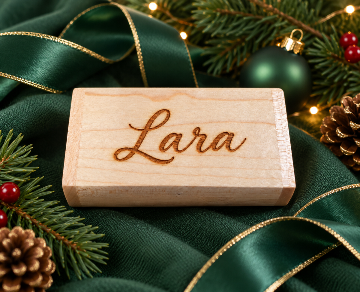 Personalised wooden jewellery box engraved with the name Lara, part of The Collective Nook Christmas gift box for her, styled with green satin ribbon and festive decorations.